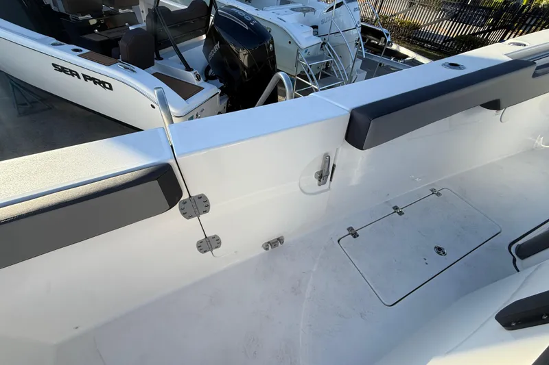 Slide: The Image of 2026 Sea Pro 292 DLX boat interior, featuring sleek design and modern seating. - 51