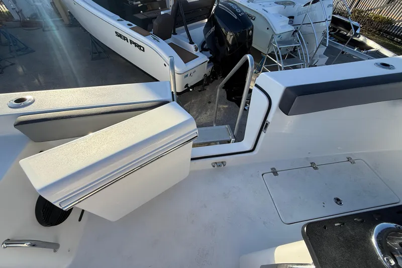 Slide: The Image of 2026 Sea Pro 292 DLX boat interior with seating and access ladder. - 52