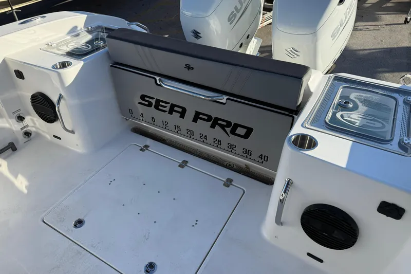 Slide: The Image of 2026 Sea Pro 292 DLX boat interior with branded seating and storage compartments. - 9