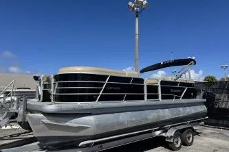 The Image of 2022 Godfrey Sweetwater 2286 C pontoon boat on trailer under clear blue sky. - 0