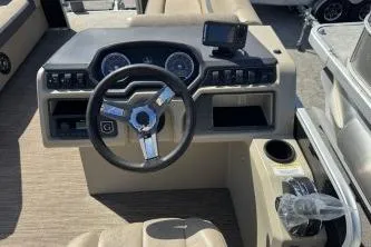 Slide: The Image of 2022 Godfrey Sweetwater 2286 C boat dashboard with steering wheel and controls. - 10