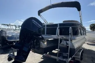 Slide: The Image of 2022 Godfrey Sweetwater 2286 C pontoon boat with Mercury outboard motor, parked on a trailer. - 14