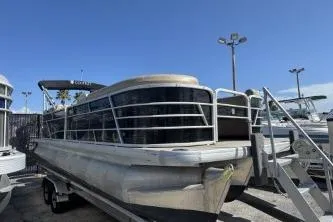 Slide: The Image of 2022 Godfrey Sweetwater 2286 C pontoon boat on trailer under clear blue sky. - 2