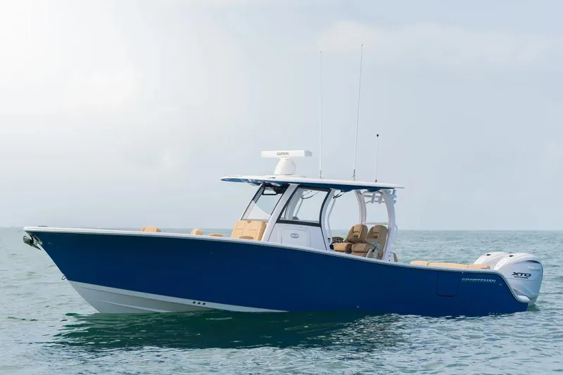 Slide: The Image of Manufacturer Provided Image: 2025 Sportsman Heritage 321 Center Console boat on calm ocean waters. - 2