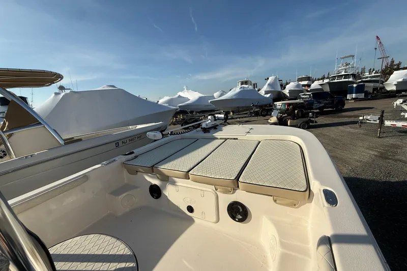 Slide: The Image of 2022 Carolina Skiff 21LS boat in marina, surrounded by covered boats and vehicles. - 3