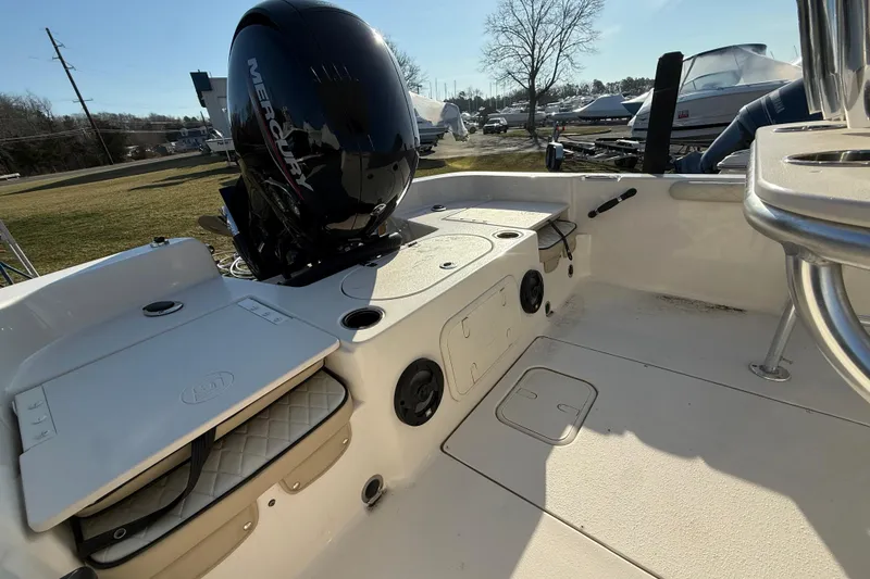 Slide: The Image of 2022 Carolina Skiff 21LS boat interior with Mercury engine, showcasing storage and seating. - 6