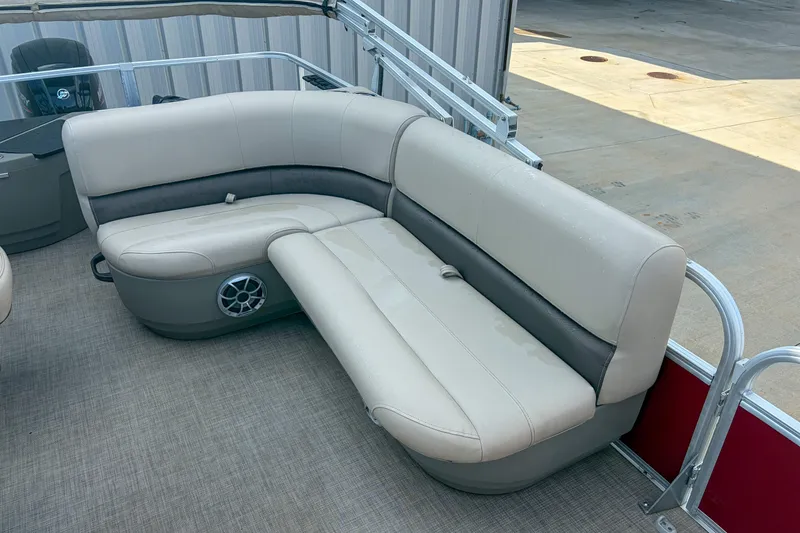 Slide: The Image of 2024 Sun Tracker Bass Buggy 18 DLX pontoon boat with beige seating and speaker. - 10