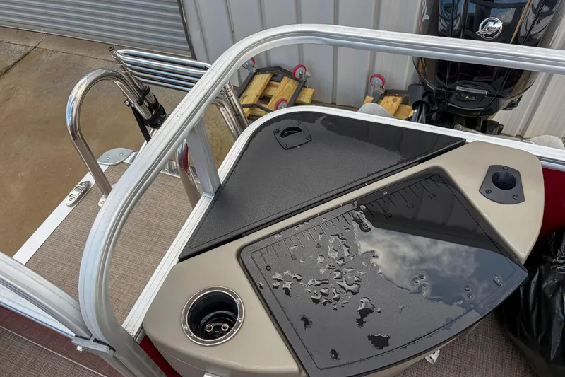 Slide: The Image of 2024 Sun Tracker Bass Buggy 18 DLX fishing station with rod holders and measuring board. - 12