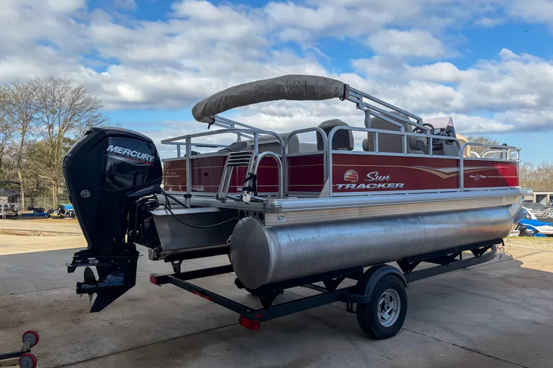 Slide: The Image of 2024 Sun Tracker Bass Buggy 18 DLX pontoon boat with Mercury engine on trailer. - 3