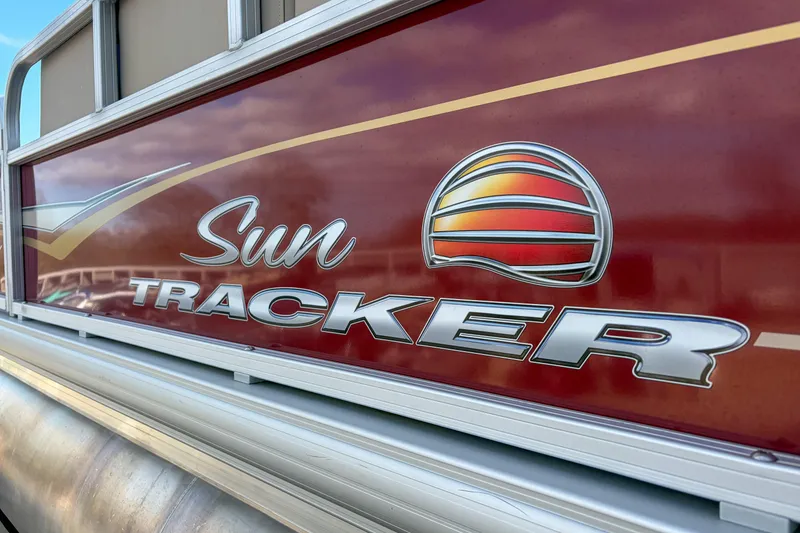 Slide: The Image of 2024 Sun Tracker Bass Buggy 18 DLX logo on a red boat panel. - 6
