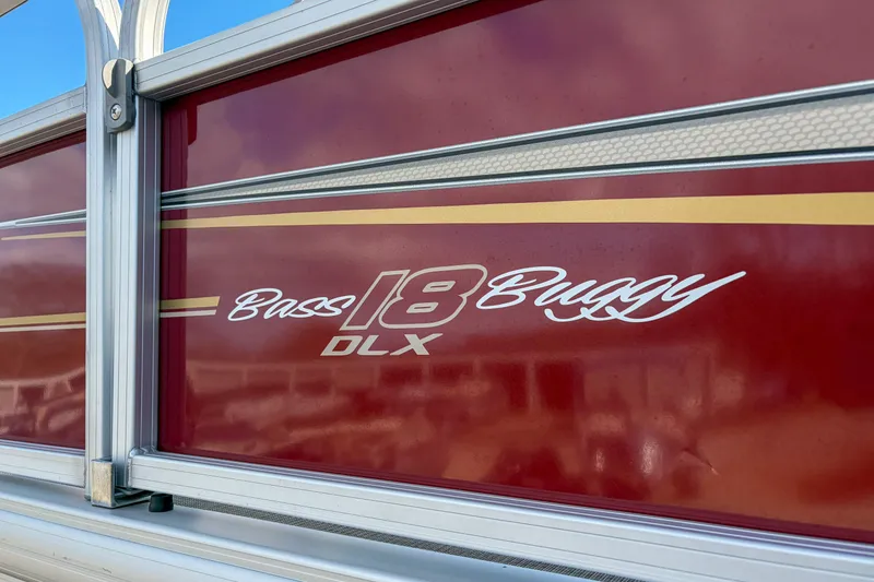 Slide: The Image of 2024 Sun Tracker Bass Buggy 18 DLX, red exterior with logo detail. - 7