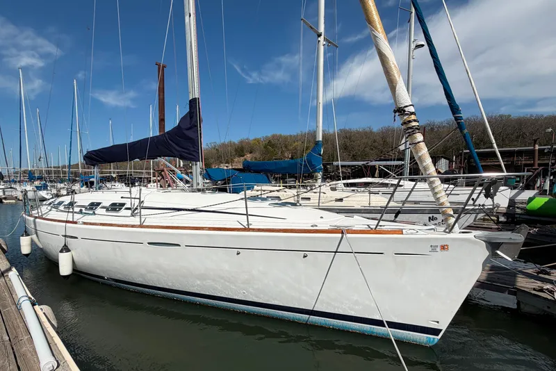 The Image of 1996 Beneteau First 42s7 sailboat docked at marina under clear blue sky. - 0