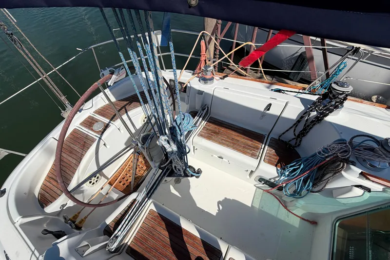 Slide: The Image of Cockpit of 1996 Beneteau First 42s7 sailboat with ropes and wooden seating. - 10