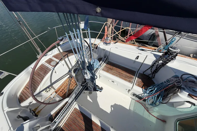 Slide: The Image of Cockpit of a 1996 Beneteau First 42s7 sailboat with ropes and wooden seating. - 11