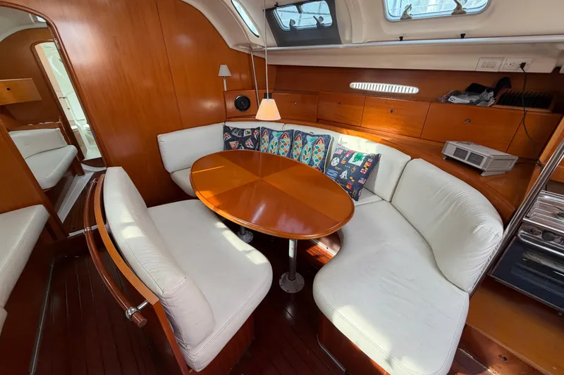 Slide: The Image of Interior of 1996 Beneteau First 42s7 yacht with cozy seating and wooden table. - 14