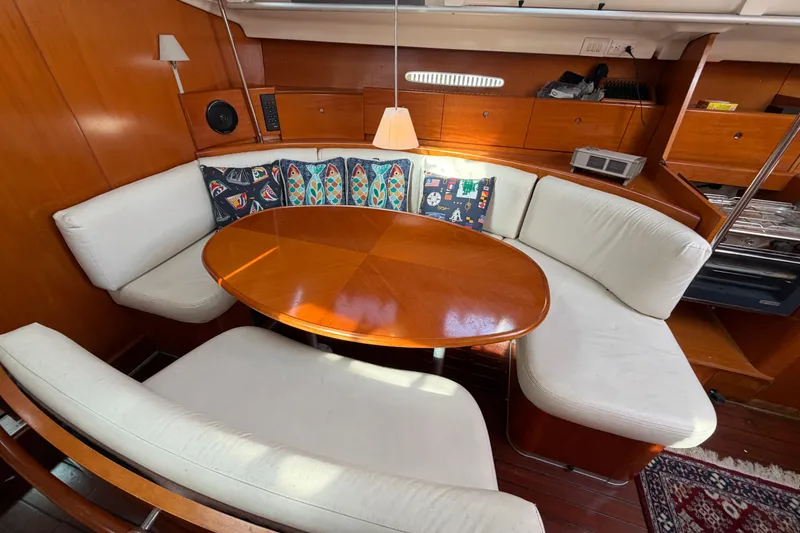 Slide: The Image of Interior of 1996 Beneteau First 42s7 yacht with elegant dining area and plush seating. - 15