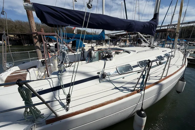 Slide: The Image of Sailboat Beneteau First 42s7, 1996 model, docked at marina with blue sail cover. - 2