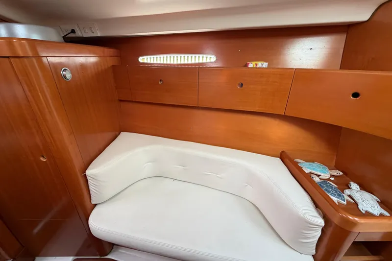 Slide: The Image of Interior cabin of 1996 Beneteau First 42s7 yacht with wooden finish and white seating. - 21