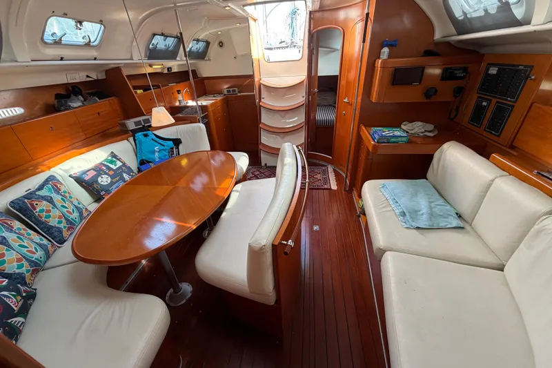 Slide: The Image of Interior of a 1996 Beneteau First 42s7 sailboat with elegant wood finish and cozy seating. - 22
