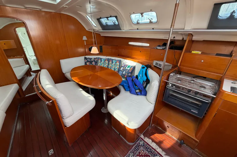 Slide: The Image of Interior of 1996 Beneteau First 42s7 sailboat with wood finish and cozy seating area. - 23