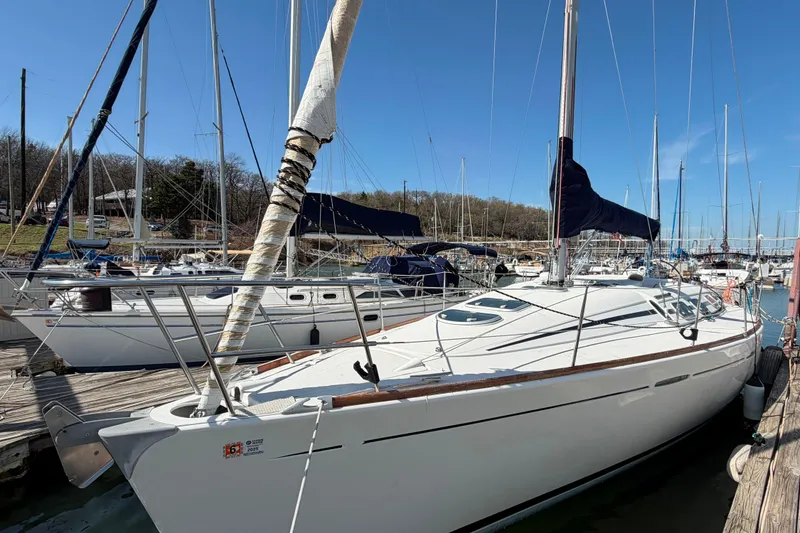 Slide: The Image of 1996 Beneteau First 42s7 sailboat docked at marina under clear blue sky. - 4