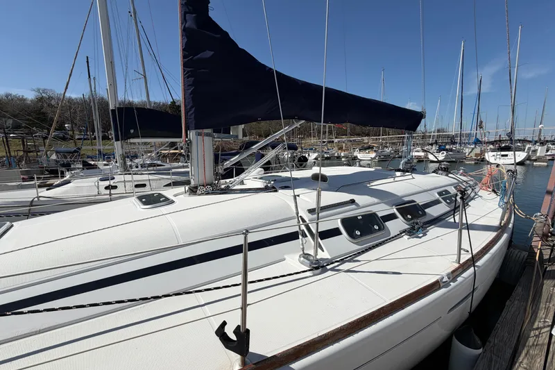 Slide: The Image of 1996 Beneteau First 42s7 sailboat docked in a marina under clear blue skies. - 5