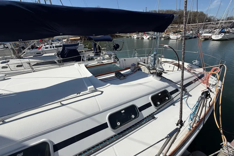 Slide: The Image of 1996 Beneteau First 42s7 sailboat docked in a marina, showcasing deck and rigging. - 6
