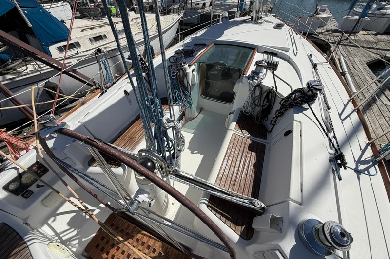 Slide: The Image of Cockpit of 1996 Beneteau First 42s7 sailboat with wooden seating and steering wheel. - 8