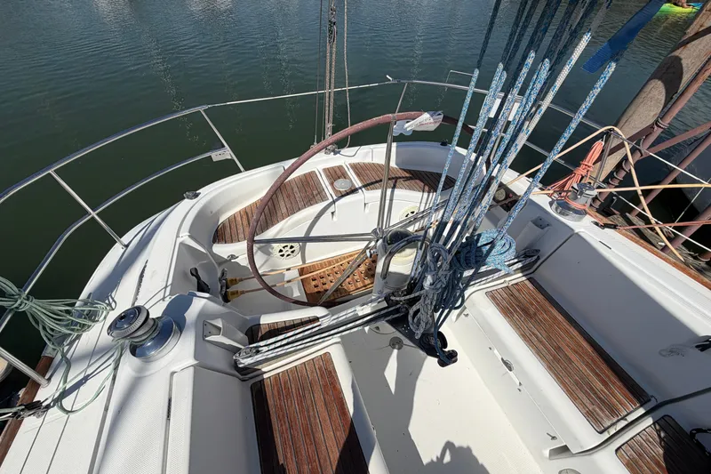 Slide: The Image of Cockpit of 1996 Beneteau First 42s7 sailboat with ropes and wooden seating. - 9