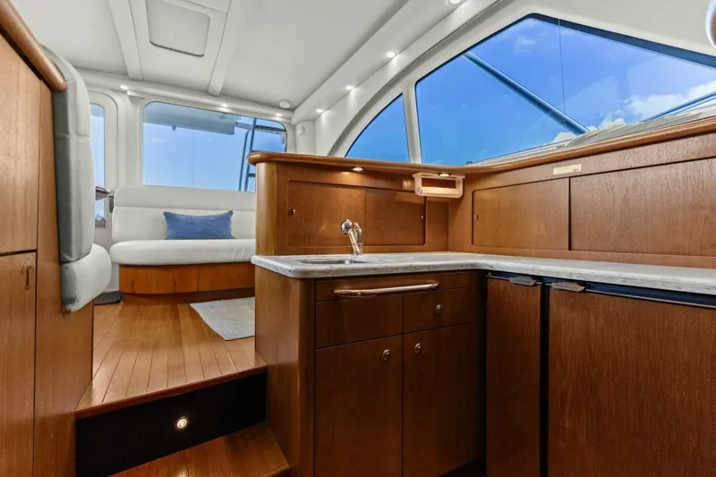 Slide: The Image of Luxurious interior of 2013 Tiara Yachts 3900 Convertible with wood cabinetry and seating. - 17