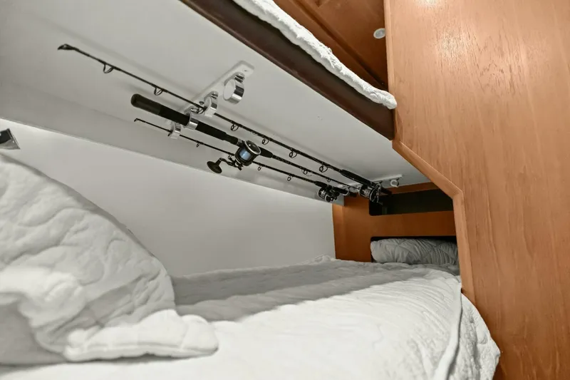 Slide: The Image of Bunk beds with fishing rod storage in 2013 Tiara Yachts 3900 Convertible. - 27
