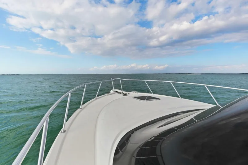 Slide: The Image of Tiara Yachts 3900 Convertible 2013 cruising on open water under a partly cloudy sky. - 29