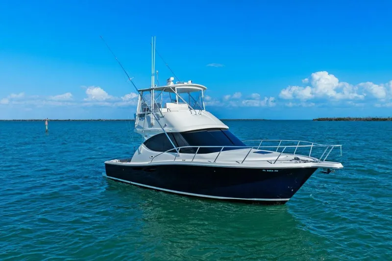 Slide: The Image of 2013 Tiara Yachts 3900 Convertible on calm blue waters under clear sky. - 49