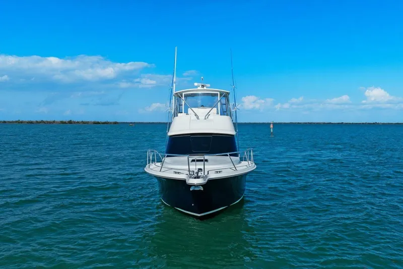 Slide: The Image of 2013 Tiara Yachts 3900 Convertible on open water under clear blue sky. - 52