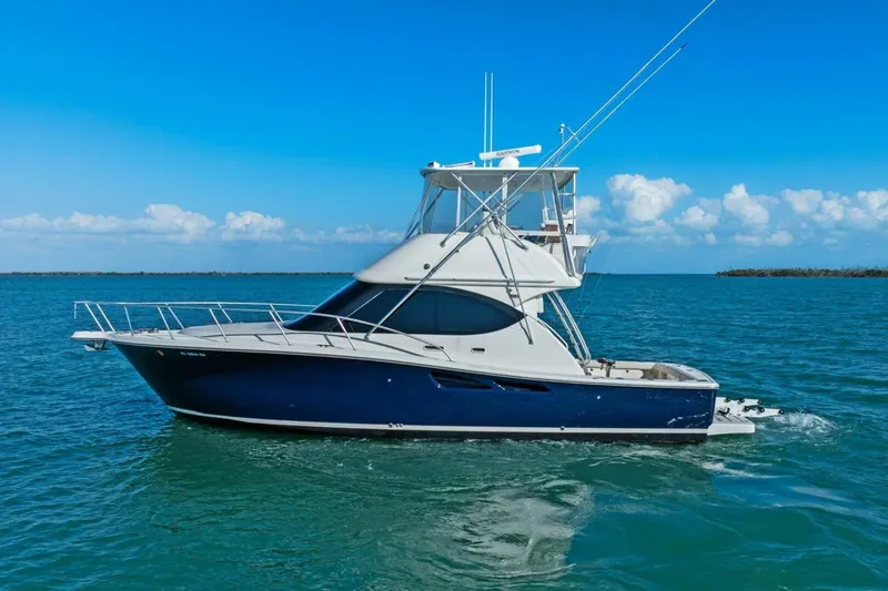 Slide: The Image of 2013 Tiara Yachts 3900 Convertible cruising on clear blue waters. - 54