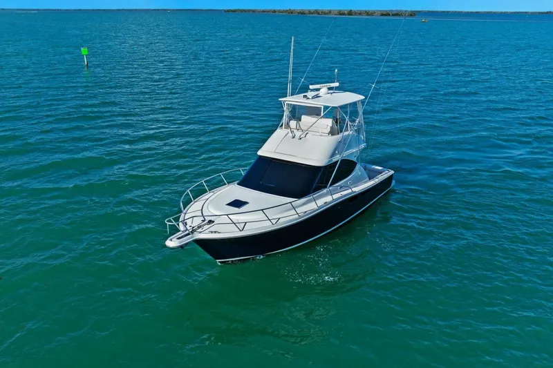 Slide: The Image of 2013 Tiara Yachts 3900 Convertible cruising on clear blue waters. - 55