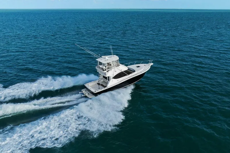 Slide: The Image of 2013 Tiara Yachts 3900 Convertible cruising on open ocean waters. - 61