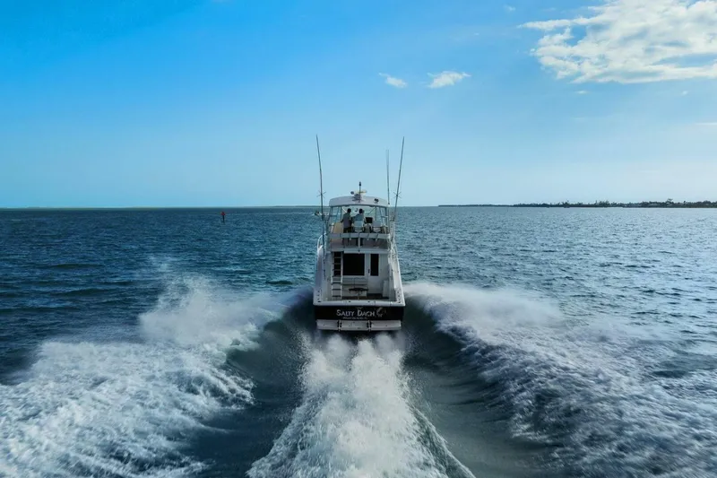 Slide: The Image of 2013 Tiara Yachts 3900 Convertible cruising on open water under clear blue sky. - 63