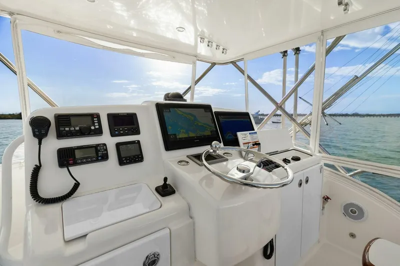 Slide: The Image of 2013 Tiara Yachts 3900 Convertible helm with navigation equipment and ocean view. - 8