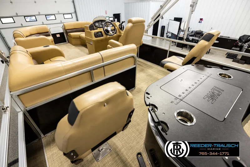 Slide: The Image of 2019 Lowe SF 212 Sport Fish boat interior with tan seating and steering console. - 11