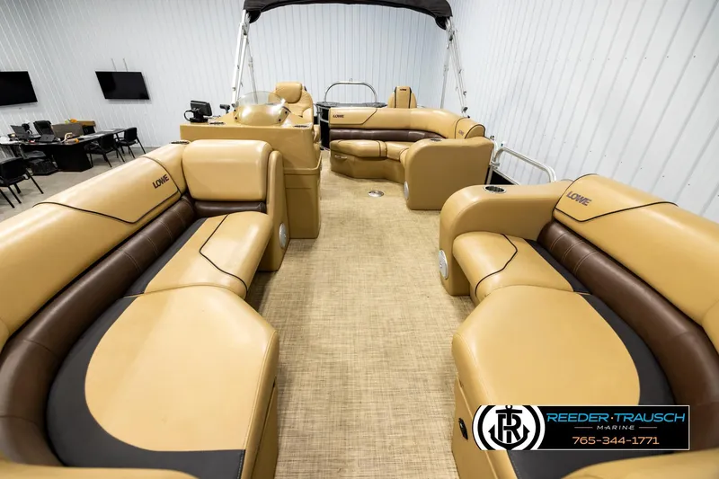Slide: The Image of 2019 Lowe SF 212 Sport Fish pontoon boat with tan seating in showroom. - 13