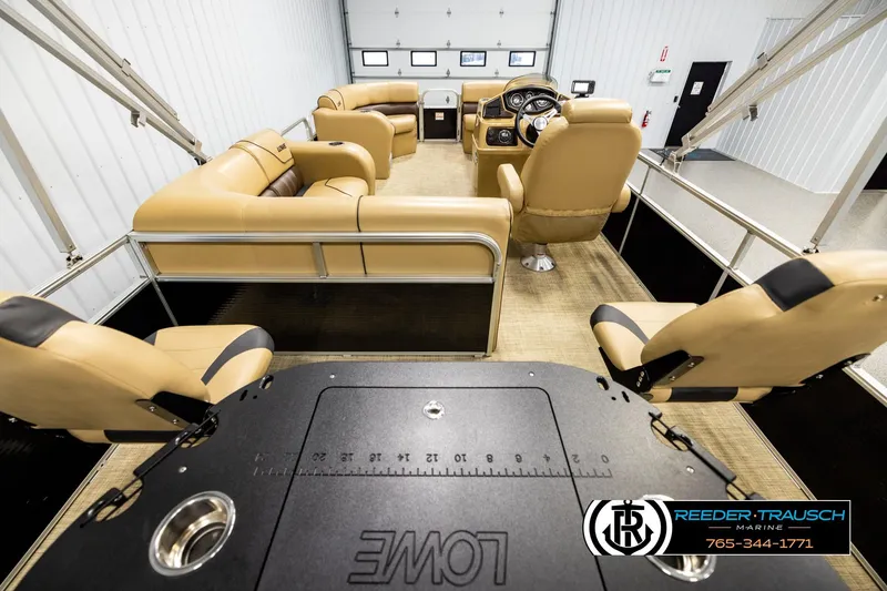 Slide: The Image of 2019 Lowe SF 212 Sport Fish pontoon boat interior with tan seating and steering console. - 16