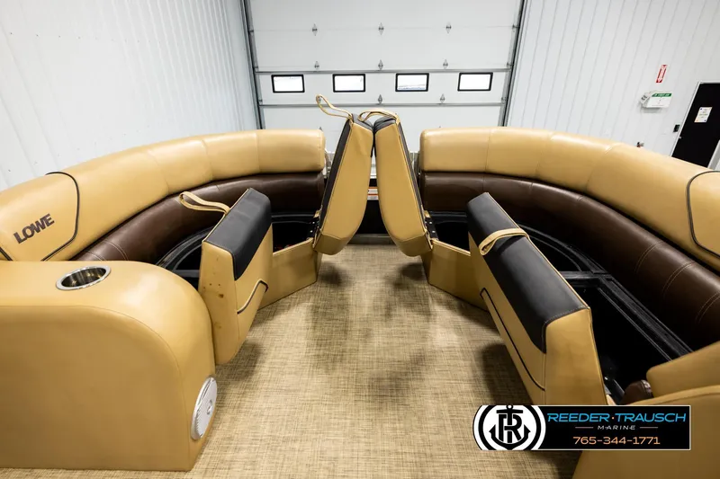 Slide: The Image of 2019 Lowe SF 212 Sport Fish boat interior with tan and brown seating in a showroom. - 19