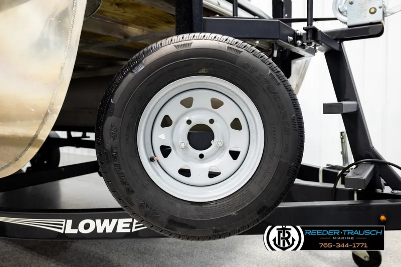 Slide: The Image of 2019 Lowe SF 212 Sport Fish trailer tire and frame detail, Reeder-Trausch Marine branding visible. - 46