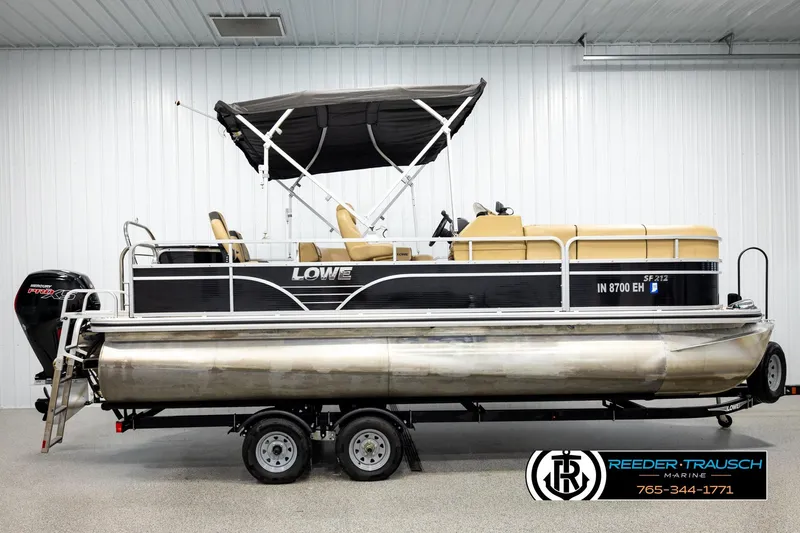 Slide: The Image of 2019 Lowe SF 212 Sport Fish pontoon boat with canopy and trailer in showroom. - 5