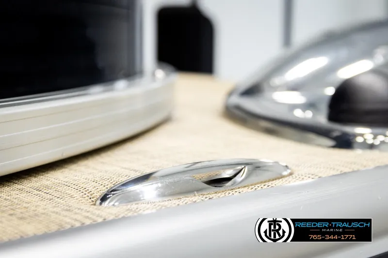 Slide: The Image of 2019 Lowe SF 212 Sport Fish boat detail with chrome handle and Reeder-Trausch Marine logo. - 50