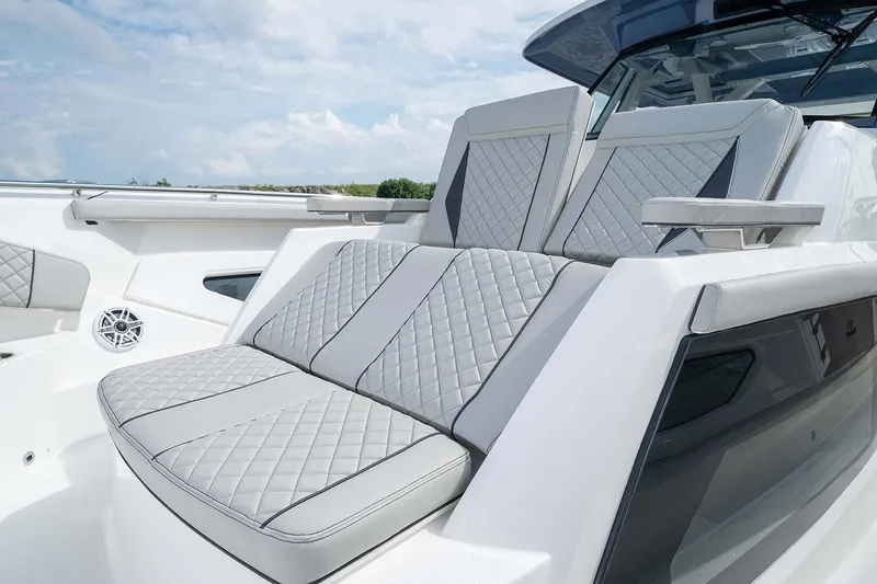 Slide: The Image of 2022 Pursuit S 428 Sport boat docked with multiple outboard engines. - 11