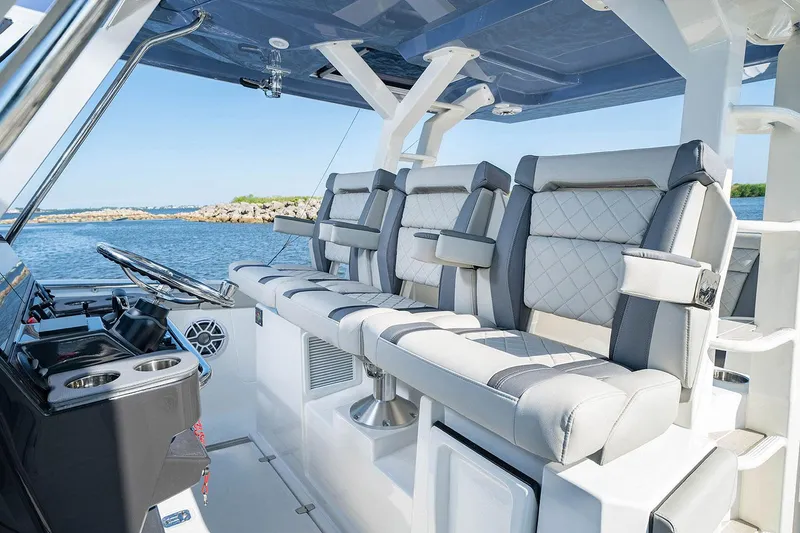 Slide: The Image of 2022 Pursuit S 428 Sport boat with four powerful outboard engines docked at marina. - 13