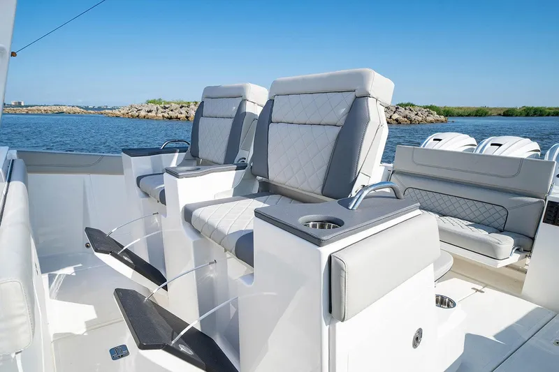 Slide: The Image of 2022 Pursuit S 428 Sport boat docked with four powerful outboard engines. - 14