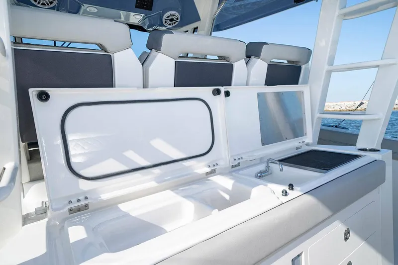 Slide: The Image of 2022 Pursuit S 428 Sport boat docked, featuring sleek design and spacious deck. - 16